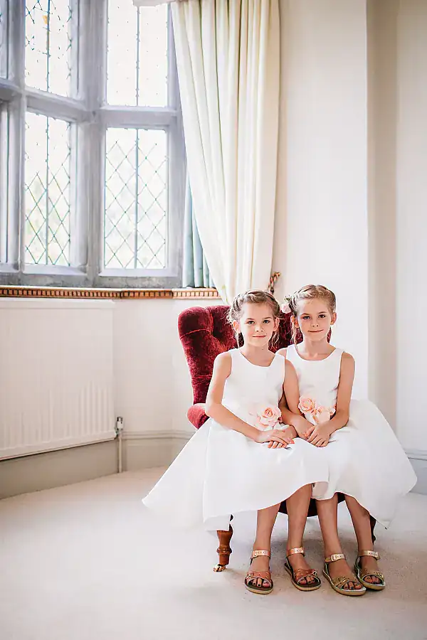 Young bridesmaids sitting on the same chair