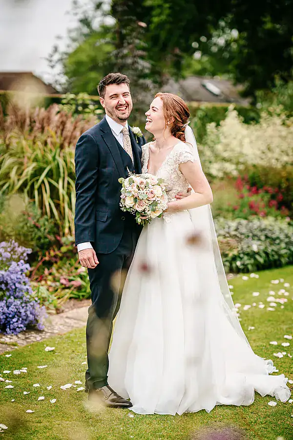 Unposed - Smiling bride and groom in gardens