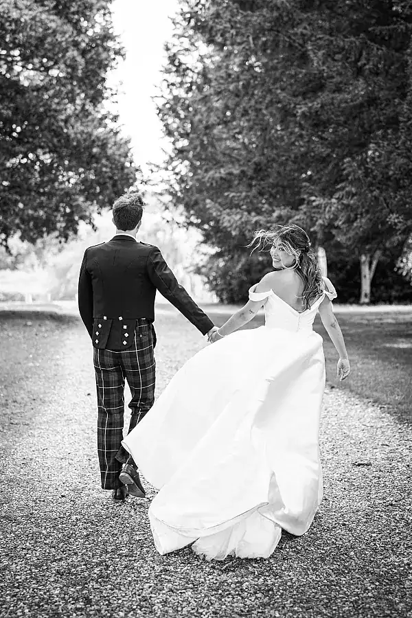 Work alone - black and white shot of happy couple with bride looking back over her shoulder