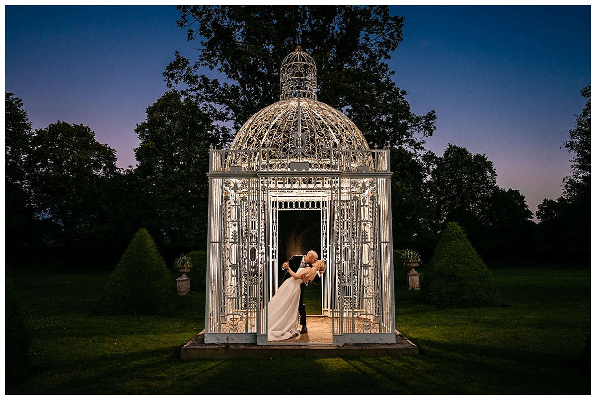 Stunning nighttime wedding photograph in Chenies Manor birdcage